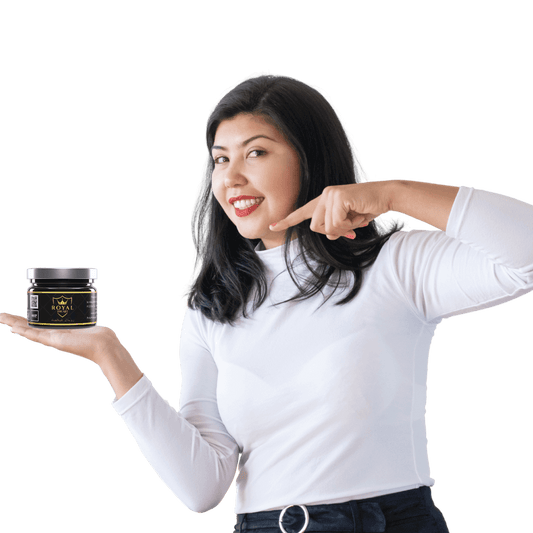 Woman holding Royal Shilajit jar, smiling and promoting wellness benefits for women.